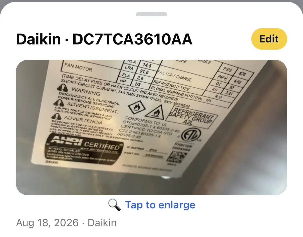 A photo of a Daikin DC7TCA3610AA data plate captured in the field, showing RLA, LRA, FLA and refrigerant safety group markings.